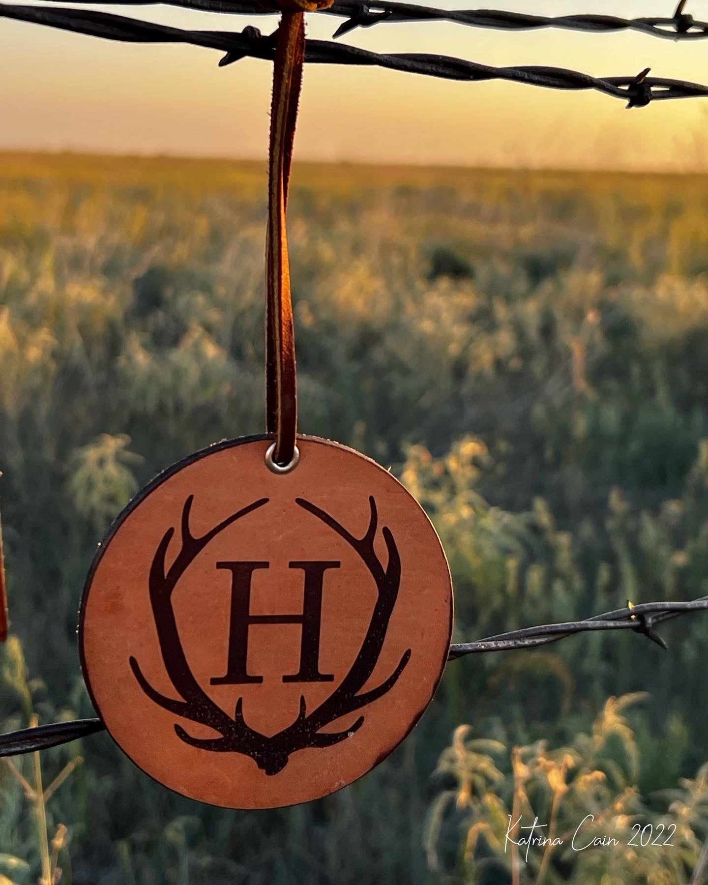 Custom Leather Freshie - circle with a set of antlers with an intitial inside