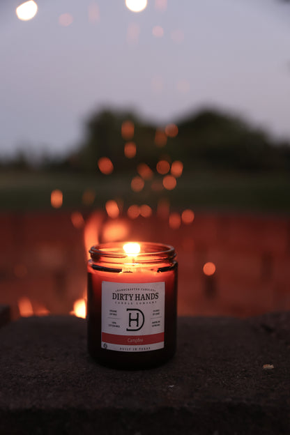 Campfire Candle Burning in front of a Camp Fire